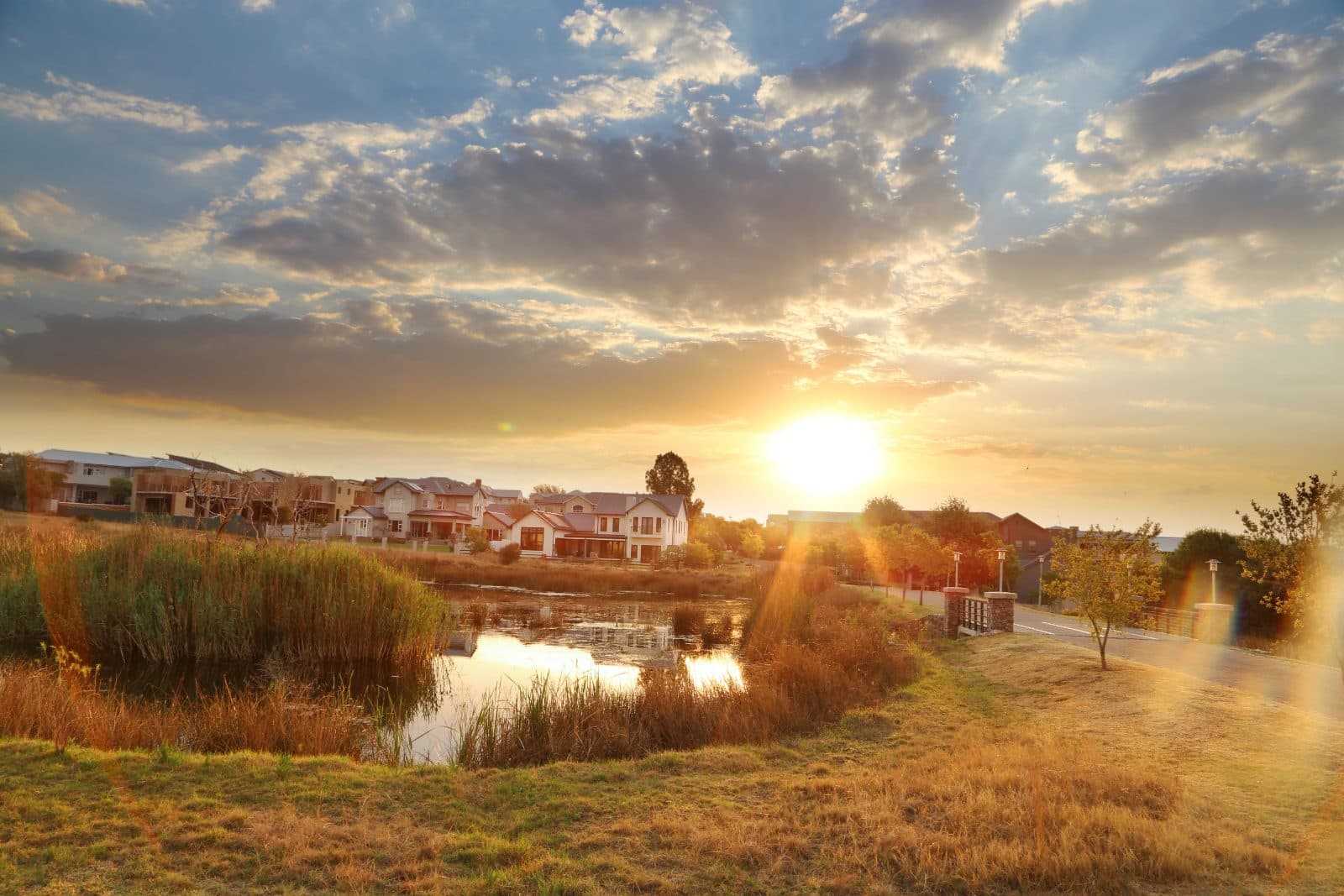 Golden hour over Waterfall City wetlands and homes
