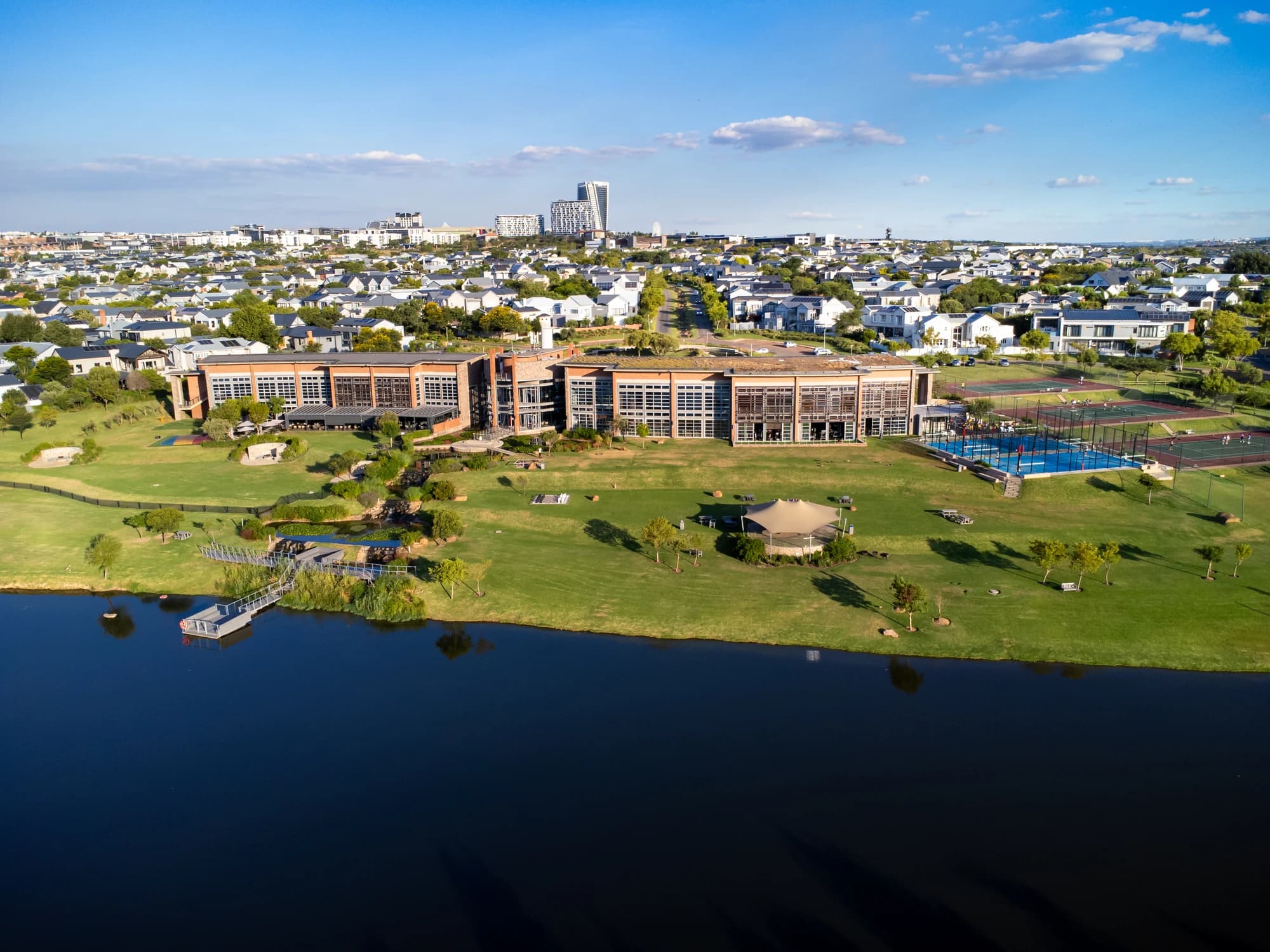 Waterfall City Country Village clubhouse, padel courts and skyline